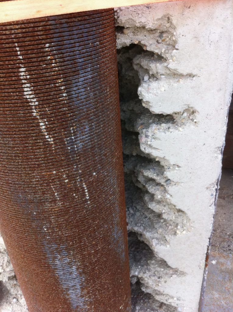 pipe encased in concrete after WellJet.