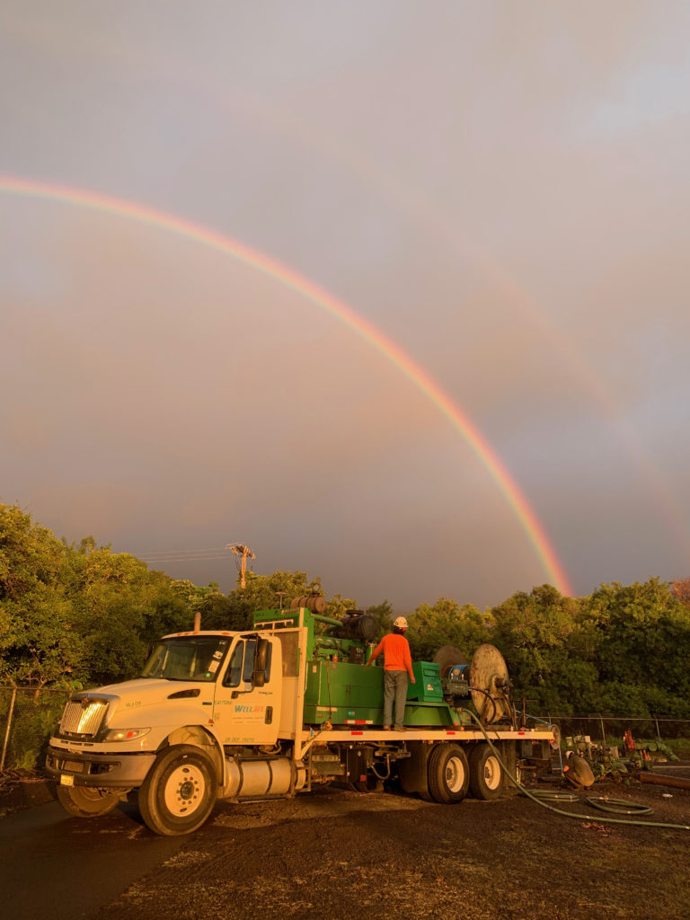 WellJet truck and equipment in Hawaii with rainbow in the background.