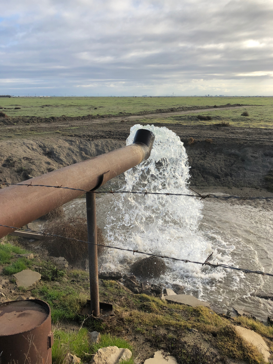 water flowing from a pipe outdoors.